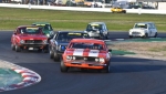 Tony Hubbard's Camaro leads Les Walmsley's Charger, the Toranas of Edwards and Girvan and the Minis of Hill and Ford