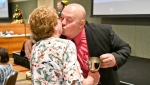 Sue Southouse collects Phil Barrow's cup and a smooch from The Genie