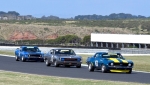 Veteran John Mann's Camaro leads Walmsley's Charger and Miceli's Mustang